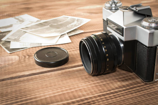 Old retro camera on a wooden background. Close up. Selective focus