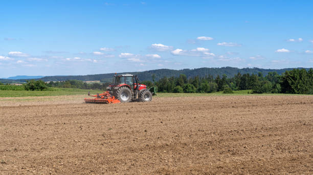 istock Tractor harrows an agricultural field 1280504030