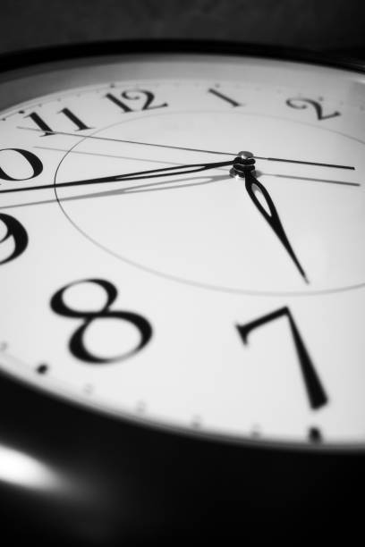 istock Close up of a wall clock on dark background 1280505018