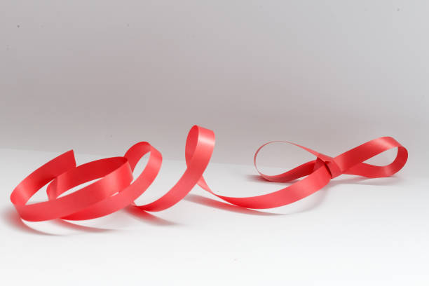 istock Shiny red satin ribbon on white background 1280505215