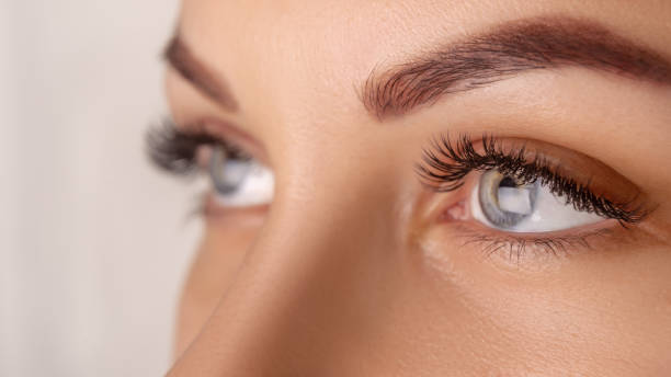 istock Eyelash Extension Procedure. Woman Eye with Long Eyelashes. Close up, selective focus 1280505481