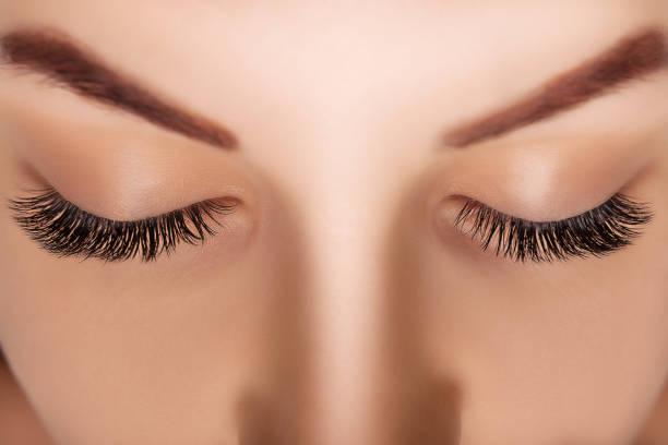 istock Eyelash Extension Procedure. Woman Eye with Long Eyelashes. Close up, selective focus 1280505539