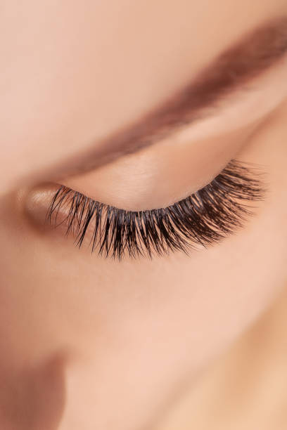 istock Eyelash Extension Procedure. Woman Eye with Long Eyelashes. Close up, selective focus 1280505589