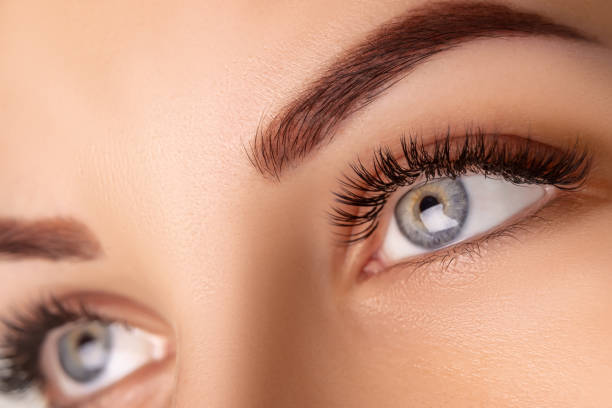 istock Eyelash Extension Procedure. Woman Eye with Long Eyelashes. Close up, selective focus 1280505636