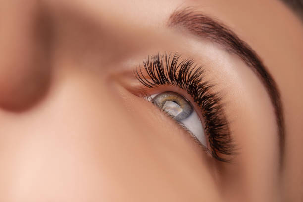 istock Eyelash Extension Procedure. Woman Eye with Long Eyelashes. Close up, selective focus 1280505673