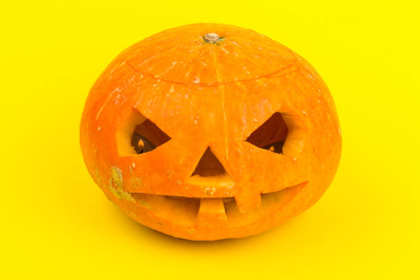 istock Halloween pumpkin head jack lantern on yellow background 1280505756