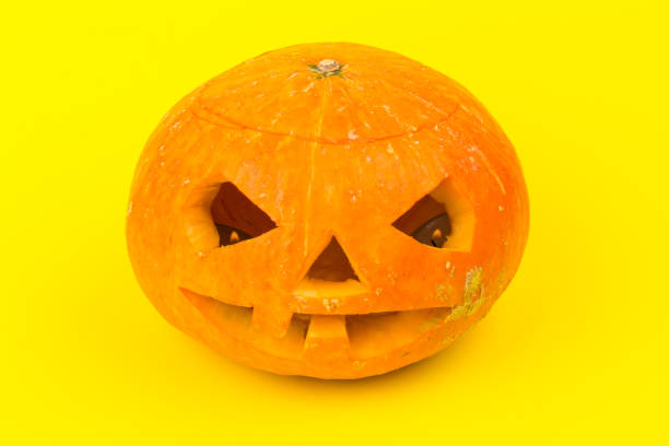 istock Halloween pumpkin head jack lantern on yellow background 1280505814