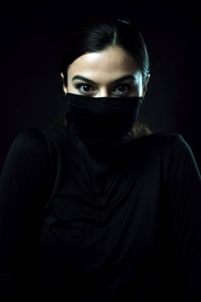 istock angry woman with mouth covered with turtleneck 1280507031