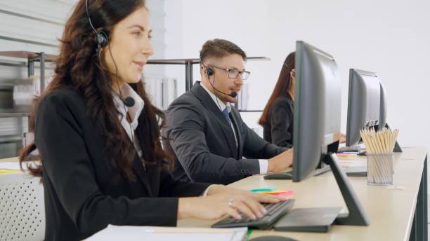 istock Business people wearing headset working in office 1280507747