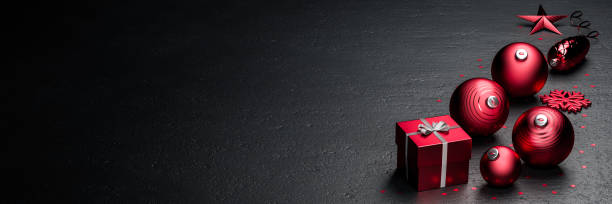 istock Red Christmas decoration on a black stone background. Banner size with copy space. 1280508312