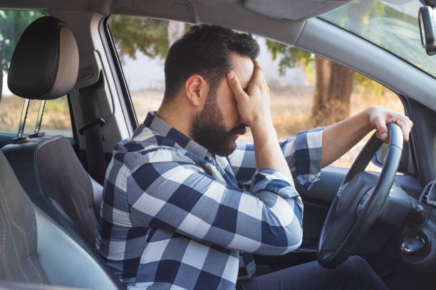 istock Young man sitting inside the car is very sad and stressed 1280509111