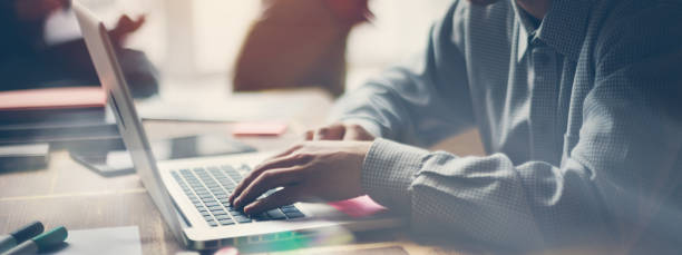 istock Man working with laptop. Modern office. Casual dress code. Blurry background, film effect, lens flare effect 1280510436