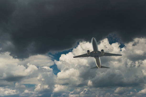 istock Commercial airplane flying through clouds in dramatic sky. Travel concept 1280510572