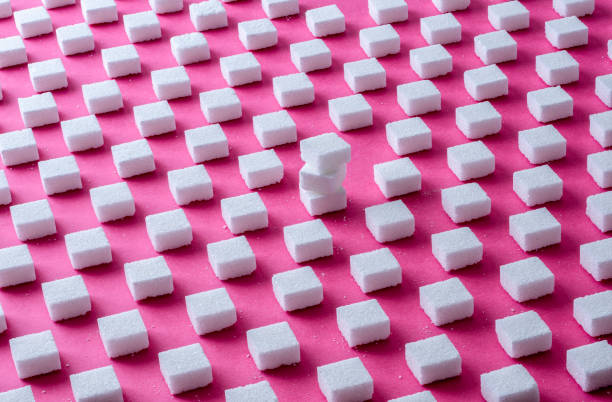istock Pattern Sugar Cubes on a Pink Background,in the middle a stack of cubes 1280510761