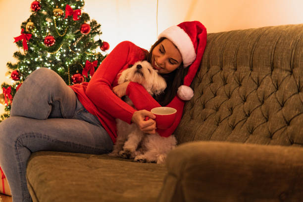 istock Woman hugging dog and drinking tea at Christmas 1280512109