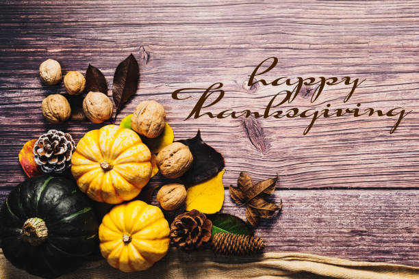 istock Happy Thanksgiving Day with pumpkin and nut on wooden table 1280512763