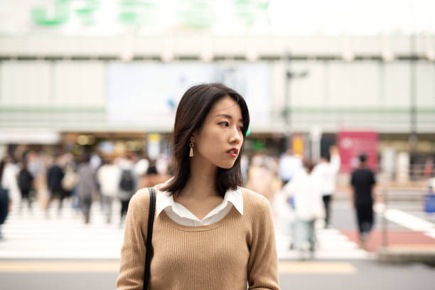 istock Young Asian woman standing out from the crowd 1280516101