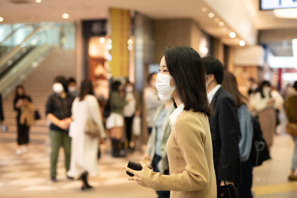 istock Selective focus of young woman among many commuters 1280516104