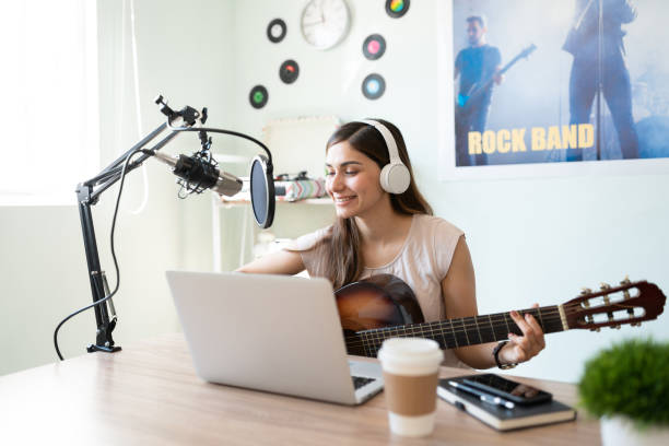istock Cute musician recording a song in her studio 1280524303