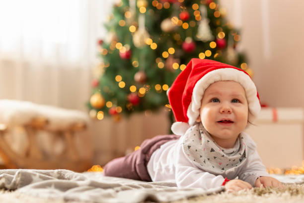 istock Baby boy lying next to a Christmas tree 1280525332