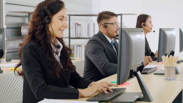 istock Business people wearing headset working in office 1280525888