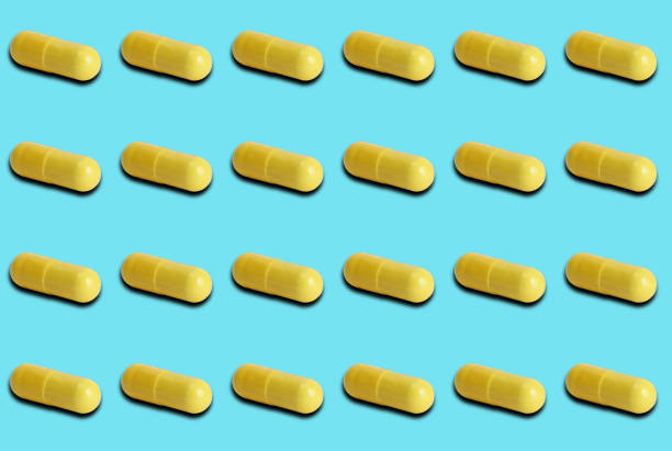 istock Group of yellow medicinal pills on pastel blue background. 1280527621