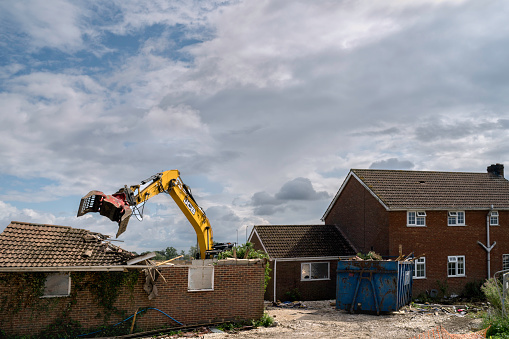 Beverley, UK - August, 07, 2019: Heavy machinery demolishes private house to make way for development of new Lidl supermarket along Minster Way on August 07, 2019 in Beverley, Yorkshire, UK.