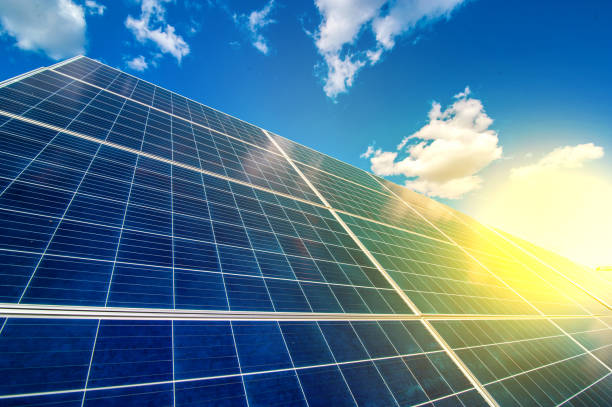 istock Solar energy panel power system, view up on the sky with clouds and sun rays 1280539752