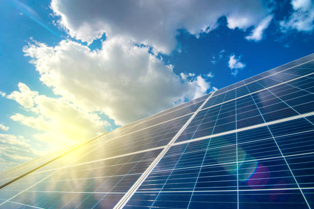 istock Solar energy panel power system, view up on the sky with clouds and sun rays 1280540355