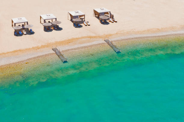 istock Beach chairs with umbrellas and beautiful sand beach 1280545473