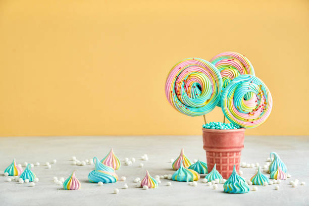 istock Meringue lollipop on yellow background. Closeup 1280547218