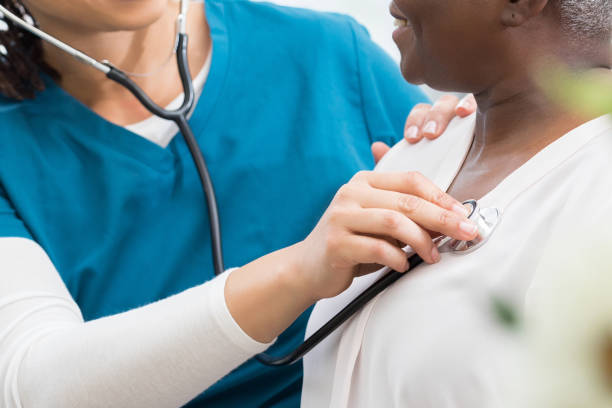 istock Caring doctor listens to patient's heart 1280549715