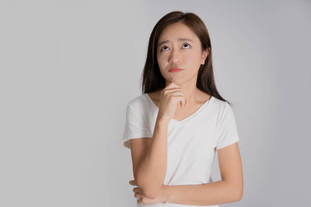 istock Asian women stand to think something. She is looking up. 1280550330
