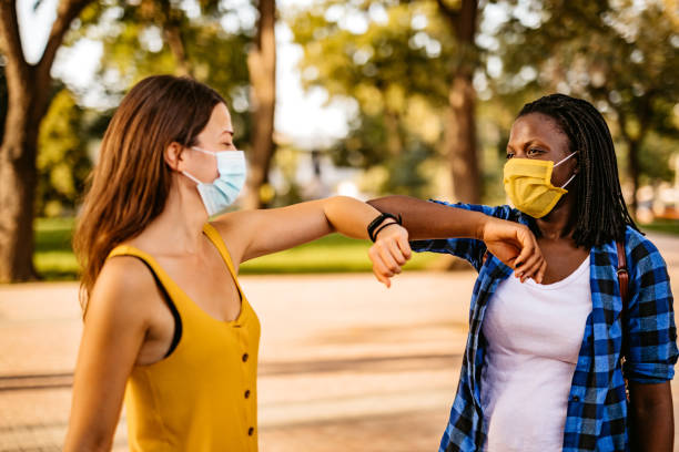 istock Two friends greeting with elbow bump 1280556723