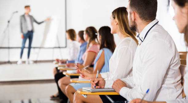 istock Side view of young people in auditorium 1280557110