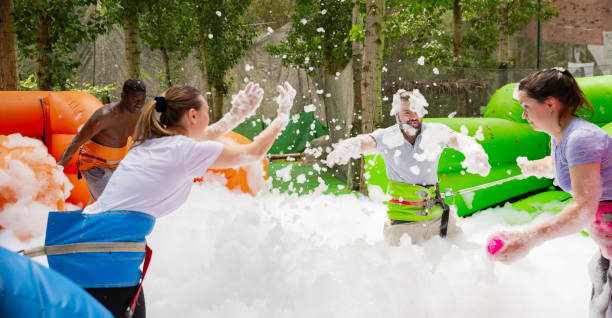 istock Friends picking up balls in inflatable pool with foam 1280557259