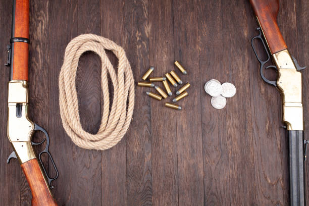 istock Wild west guns - lever-action repeating rifles with ammunition 1280558577