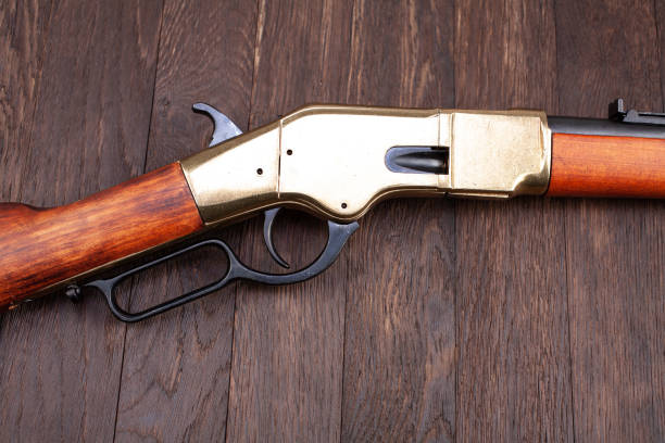 Wild west gun - lever-action repeating rifle on wooden table