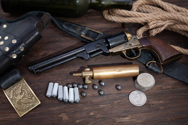 firearms of the old west - percussion army revolver with paper cartridges, bullets, powder flask and holster - 1866 imagens e fotografias de stock