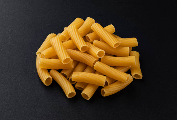istock Raw spiral tortiglioni pasta isolated on black background 1280559582