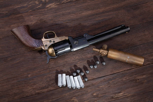 firearms of the old west - percussion army revolver with paper cartridges, bullets and powder flask - 1866 imagens e fotografias de stock