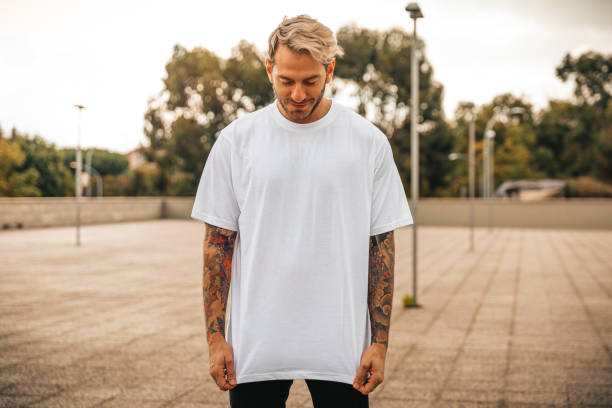Portrait of tattooed young man Portrait of tattooed young man with white t-shirt white people stock pictures, royalty-free photos & images