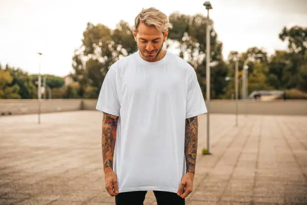 Portrait of tattooed young man with white t-shirt