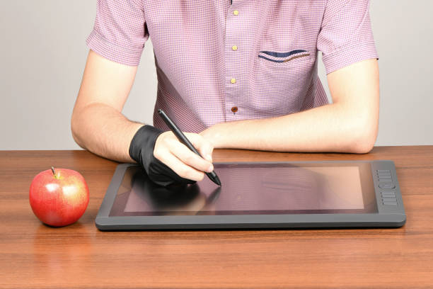 istock Man works on black graphic monitor 1280565890