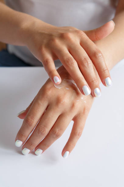 istock Woman smearing soft moisturizer on hands skin 1280566367