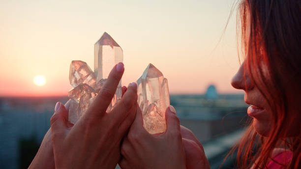 istock Sisters meditating with healing crystals. Rooftop view 1280567797