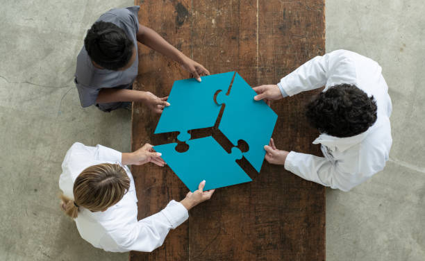 istock Medical professionals putting a 3 piece puzzle together 1280567827