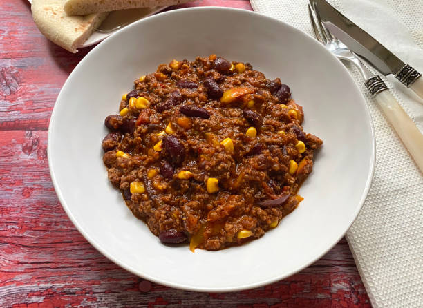 istock Chili con carne with minced beef, tomatoes, chilli peppers, beans, corn, onions, garlic and bell pepper. Served with flat bread. 1280567903