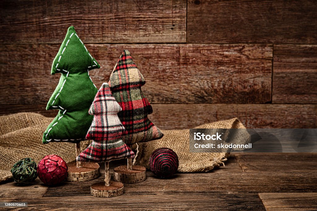 Christmas tree decorations on a retro wood background This is a photograph of three handmade craft Christmas trees on a wood background Christmas Stock Photo