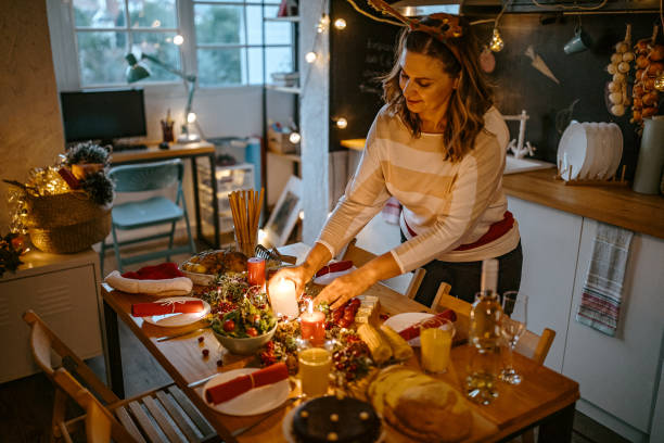 istock Woman arranging table for Christmas dinner at home 1280571079